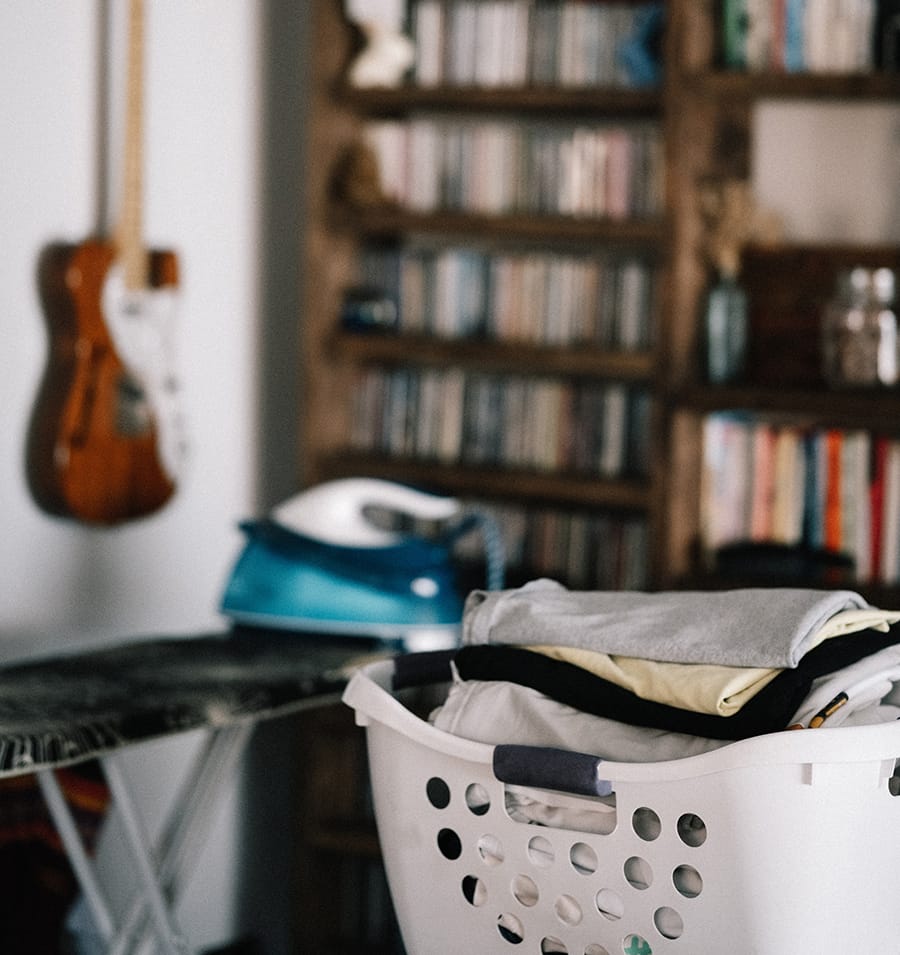 washing basket with guitar and books in the background